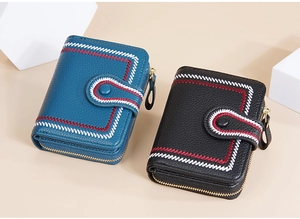 Detail of short wallets with geometric embroidery, litchi texture and zip buckle closure