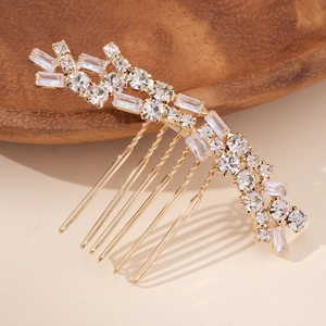 Elegant gold hair comb with clear crystals and zircons in an irregular vine design