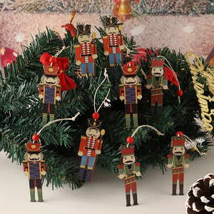 Set of 8 wooden nutcracker soldier ornaments hanging on a festive Christmas tree branch