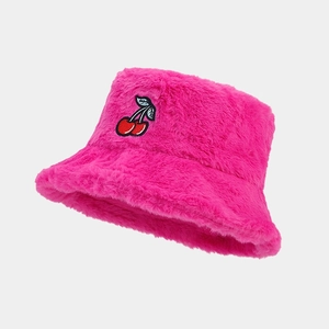 Close-up of rose pink fuzzy bucket hat with detailed red cherry embroidery pattern