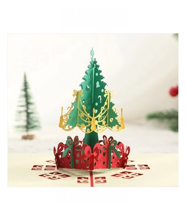 Macro detail of 3D pop-up Christmas tree card featuring laser-cut hollow patterns