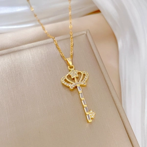 Golden crown key necklace with sparkling crystals on a minimalist chain for women