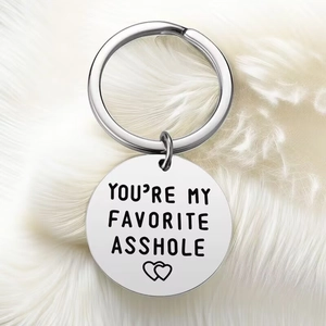 Macro shot of silver stainless steel key ring with heart-shaped engraving detail