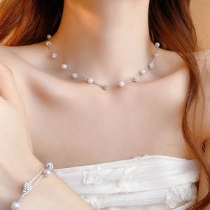 Double-layered pearl necklace and bracelet set with rhinestone balls on a model