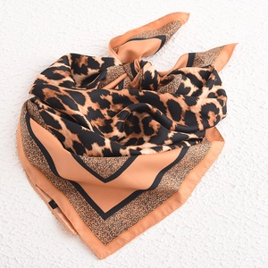 Brown leopard print square silk scarf with geometric pattern on white textured background
