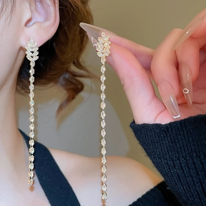 Detail of 18K gold plated tassel earrings featuring shimmering zircon marquise stones