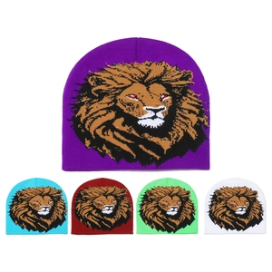 Detail of five colored knit beanies with a distinctive lion head jacquard pattern