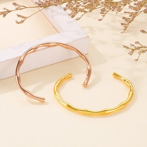 Bamboo style open bangles in gold and rose gold finish with a polished metal surface
