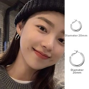 Silver hoop earrings in two sizes, diameter 20mm and 26mm, shown on a model