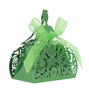 Detail of green laser-cut gift box featuring intricate hollow floral patterns and ribbon