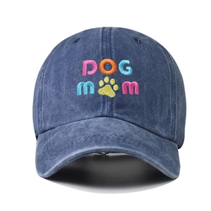 Detail of the colorful DOG MOM embroidery on this navy blue washed cotton baseball cap