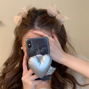 Model wearing champagne pink mesh bow hair clips for a stylish side hairstyle