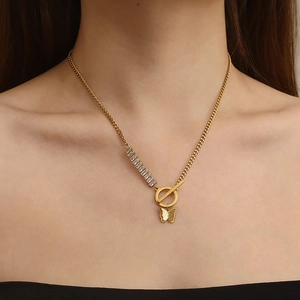 Golden butterfly necklace with zircon stones and T-bar closure worn by a model