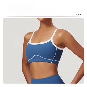 Detailed close-up of blue sports bra with white contrast stitching and slim straps