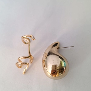 Detail view of gold-plated spiral ear cuff with zircon and polished drop earring set