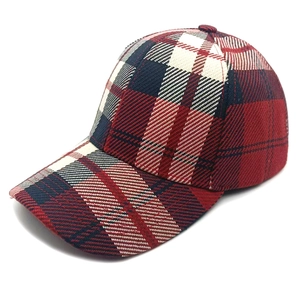 Detail of red and blue plaid baseball cap with durable twill texture and curved brim