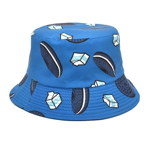 Close-up of a blue bucket hat with cookies and milk patterns on cotton canvas fabric