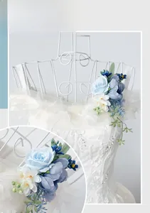 Detail of blue faux rose shoulder flower accessory on a bridal wedding dress