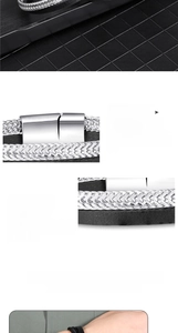 Detail of silver alloy magnetic clasp and black braided PU leather texture on bracelet