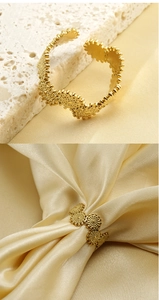 Detailed view of gold textured open bangle used as a stylish silk scarf buckle accessory