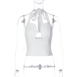 Detail view of the deep U-neckline and white ribbed fabric on the halter top