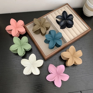 Matte flower hair claws in eight colors including pink and green for elegant styling