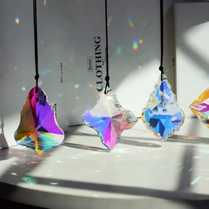 Detailed close-up of crystal suncatcher prisms showing rainbow light refraction in sunlight