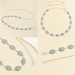 Macro detail of Bohemian silver metal waist chain with turquoise stones and floral carvings