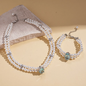Double-layer pearl necklace and bracelet set with blue gemstone and silver flower accents