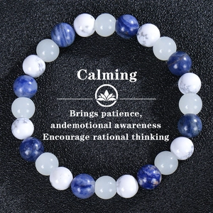 Calming beaded bracelet with blue sodalite and white turquoise stones on black background