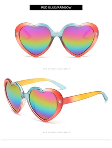 Detail of heart-shaped sunglasses with red-blue gradient frame and rainbow lenses