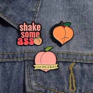 Three-piece set of pink peach enamel pins with funny slogans on blue denim fabric