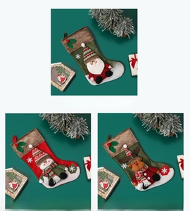 Detailed view of large Christmas stockings featuring 3D Santa, snowman and elk motifs