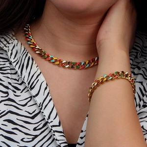 Gold Cuban chain necklace and bracelet set with colorful enamel charms on a model