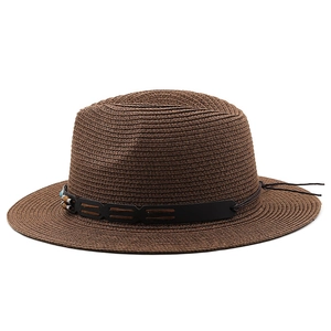 Close-up of deep brown straw Panama hat with black leather band and beaded accents