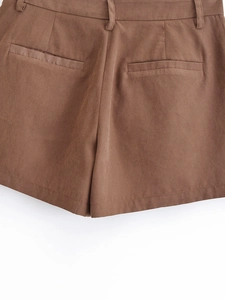 Rear view of high-waisted brown mini shorts with belt loops and welt pocket details