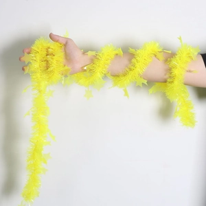 Close-up of yellow star tinsel garland held in hand for Christmas tree decoration
