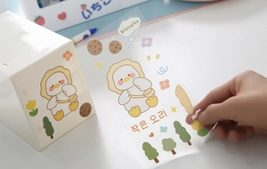 Detail of applying waterproof cartoon PET stickers with cute duck design on storage box