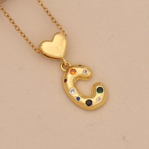 Detail of golden heart-shaped clasp and colorful zircon encrusted letter C pendant