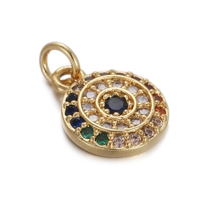 Detailed macro view of a circular gold pendant with a central black gem and colorful halo