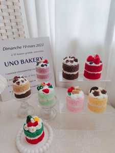Close-up of assorted realistic dessert candles with strawberry and chocolate details