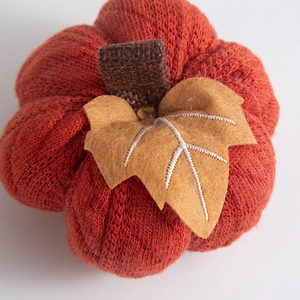 Orange knitted pumpkin decoration with burlap stem for harvest and thanksgiving decor