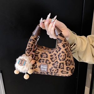 Handheld trendy leopard print crossbody bag with plush charm and logo in brown finish