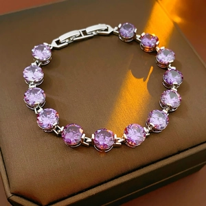 Elegant silver tennis bracelet with circular purple zircons and secure jewelry clasp