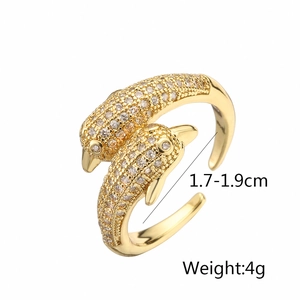 Macro shot of gold-plated dolphin ring with cubic zirconia showing 1.7-1.9cm inner diameter