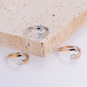 Three minimalist stainless steel open rings with heart-shaped zircon in gold, silver and rose gold
