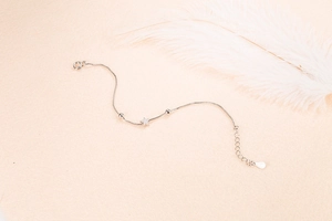 Minimalist silver star charm bracelet with delicate beads and adjustable chain extension