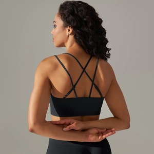 Detail view of black seamless sports bra featuring a criss-cross back strap design