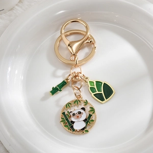 Detail of panda bamboo and shoot enamel pendants on a gold-plated metal keychain