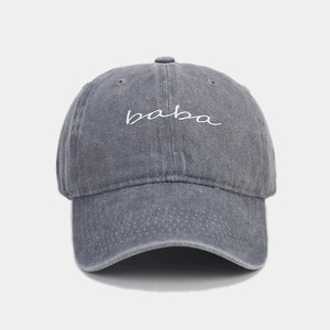 Nahaufnahme der weißen baba-Stickerei auf der grau gewaschenen Baseballkappe aus Denim